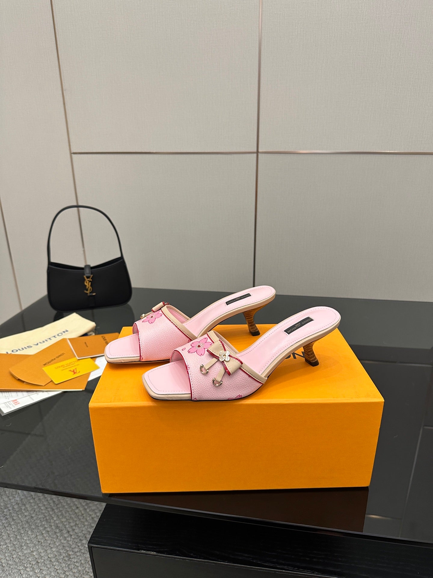 Pink slide sandals with floral strap charms and sculpted low heel