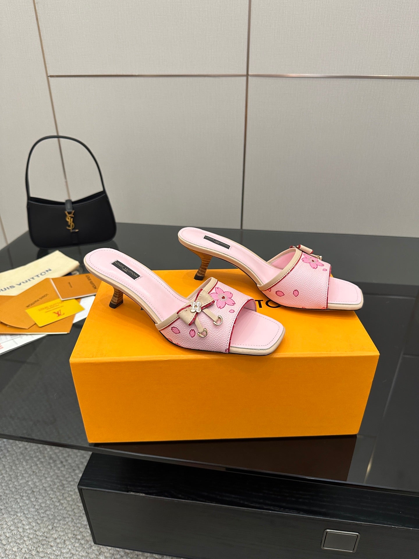 Pink slide sandals with flower appliqué, buckle strap, and chunky block heel