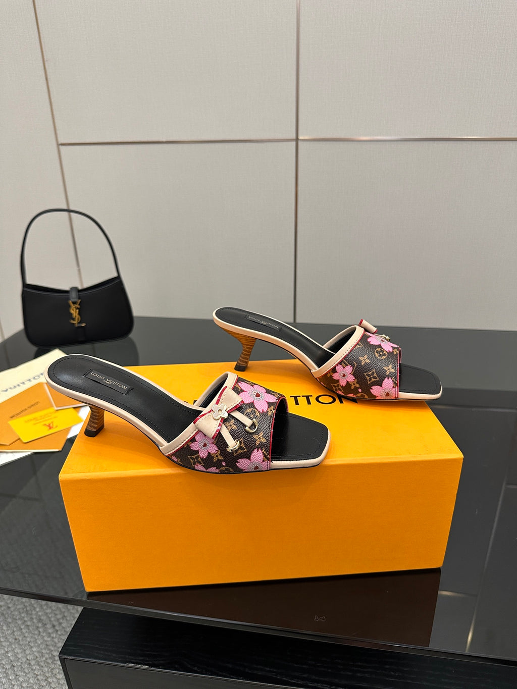 Women's heeled slides, black floral upper with pink ribbon bow, tan mid heel