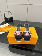 Women's heeled mules, black with pink floral print, pink bows, gold heel trim