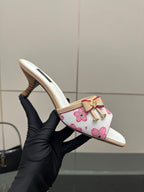 Louis Vuitton women’s floral mule slides, viewed in hand with open toe and heel