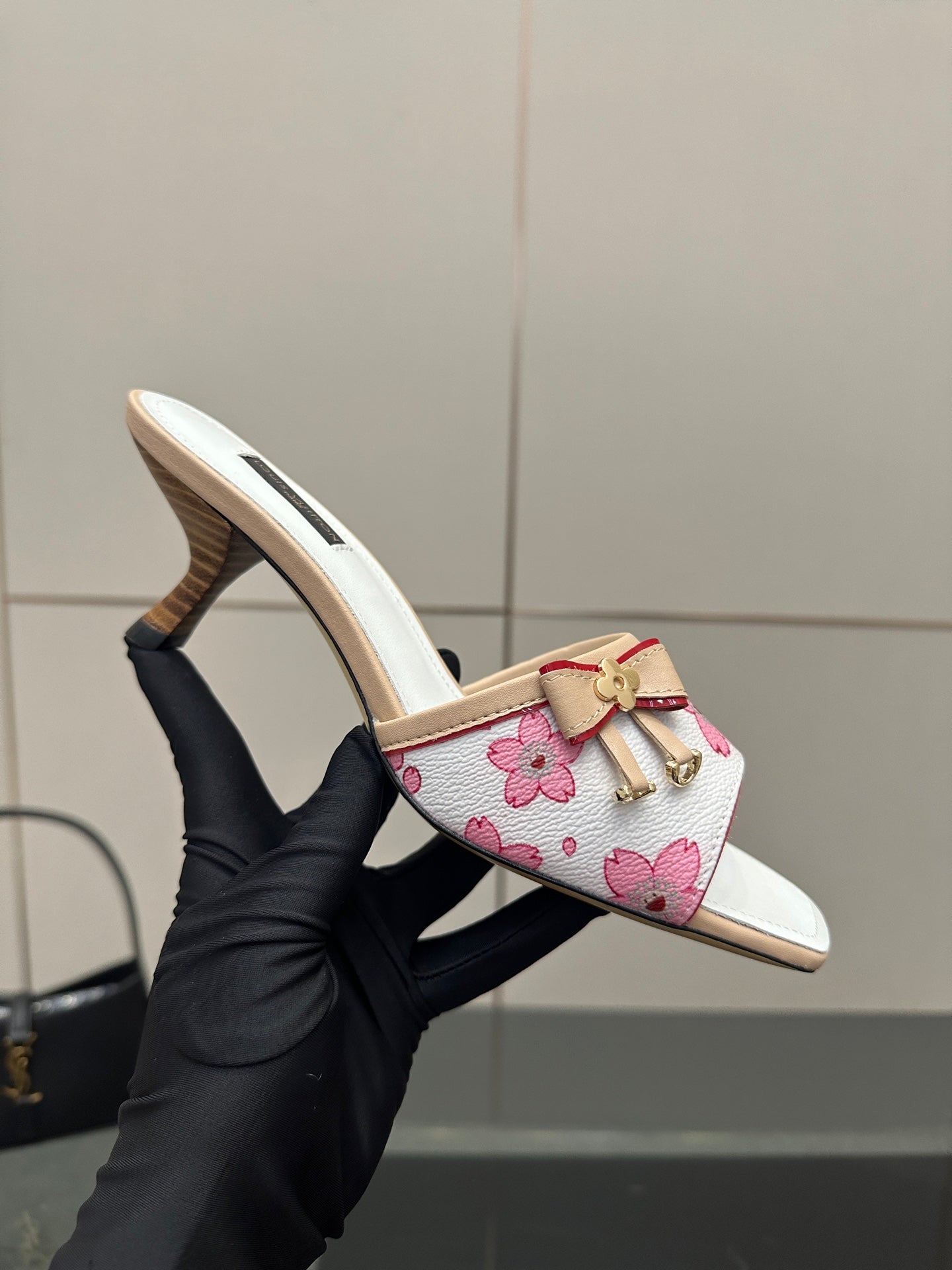 Louis Vuitton women’s floral mule slides, viewed in hand with open toe and heel