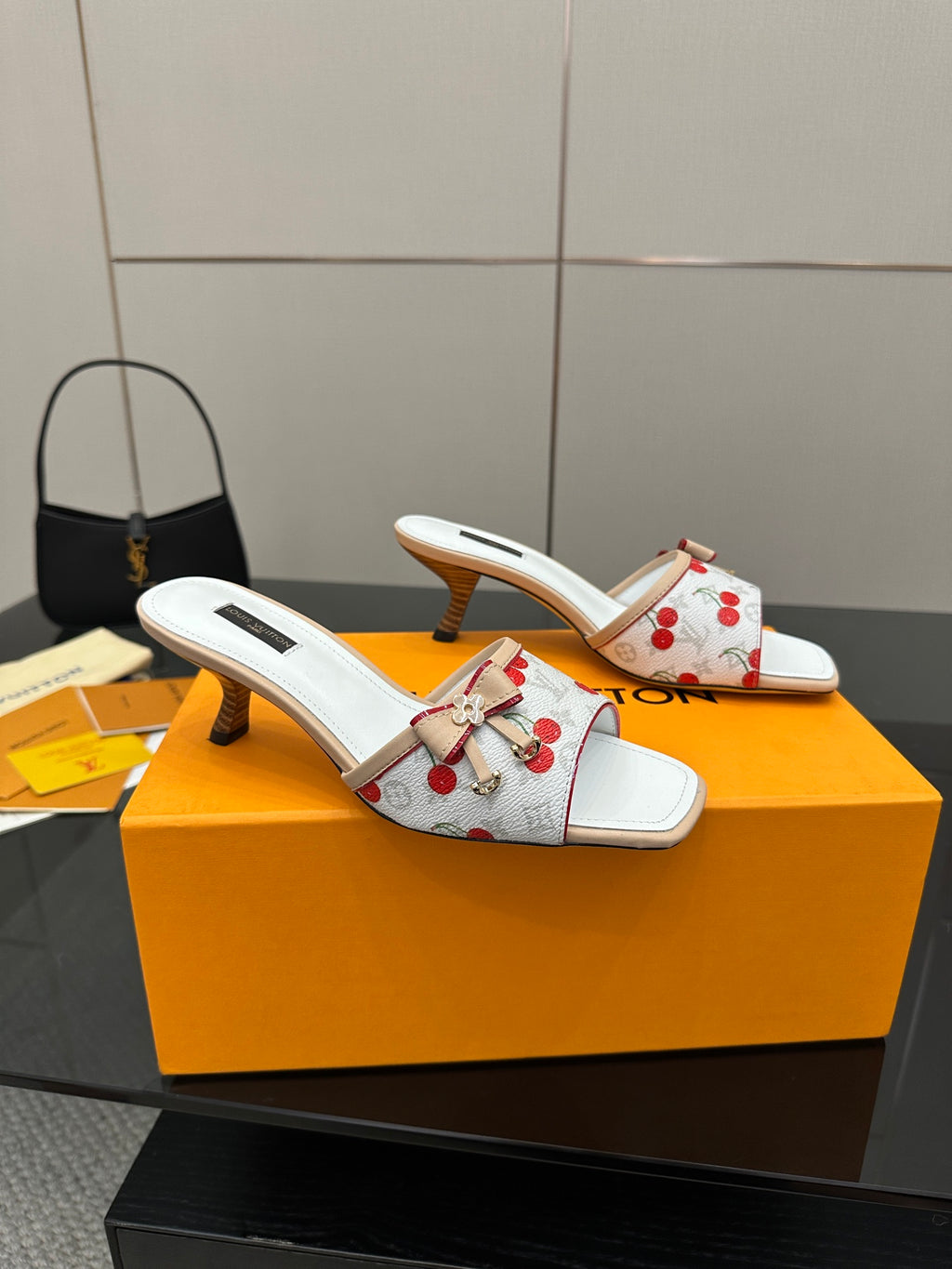 Pair of women’s cherry-print mules in white with ribbon bow and mid block heel