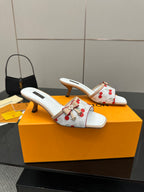 Pair of women’s cherry-print mules in white with ribbon bow and mid block heel