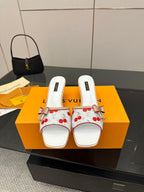 Women’s Louis Vuitton mules, white with red cherry print and gold bow charms