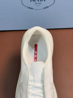Prada unisex sneaker interior view, light cream leather upper and white laces