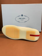 Prada unisex sneaker outsole, light cream rubber sole with Prada branding on heel