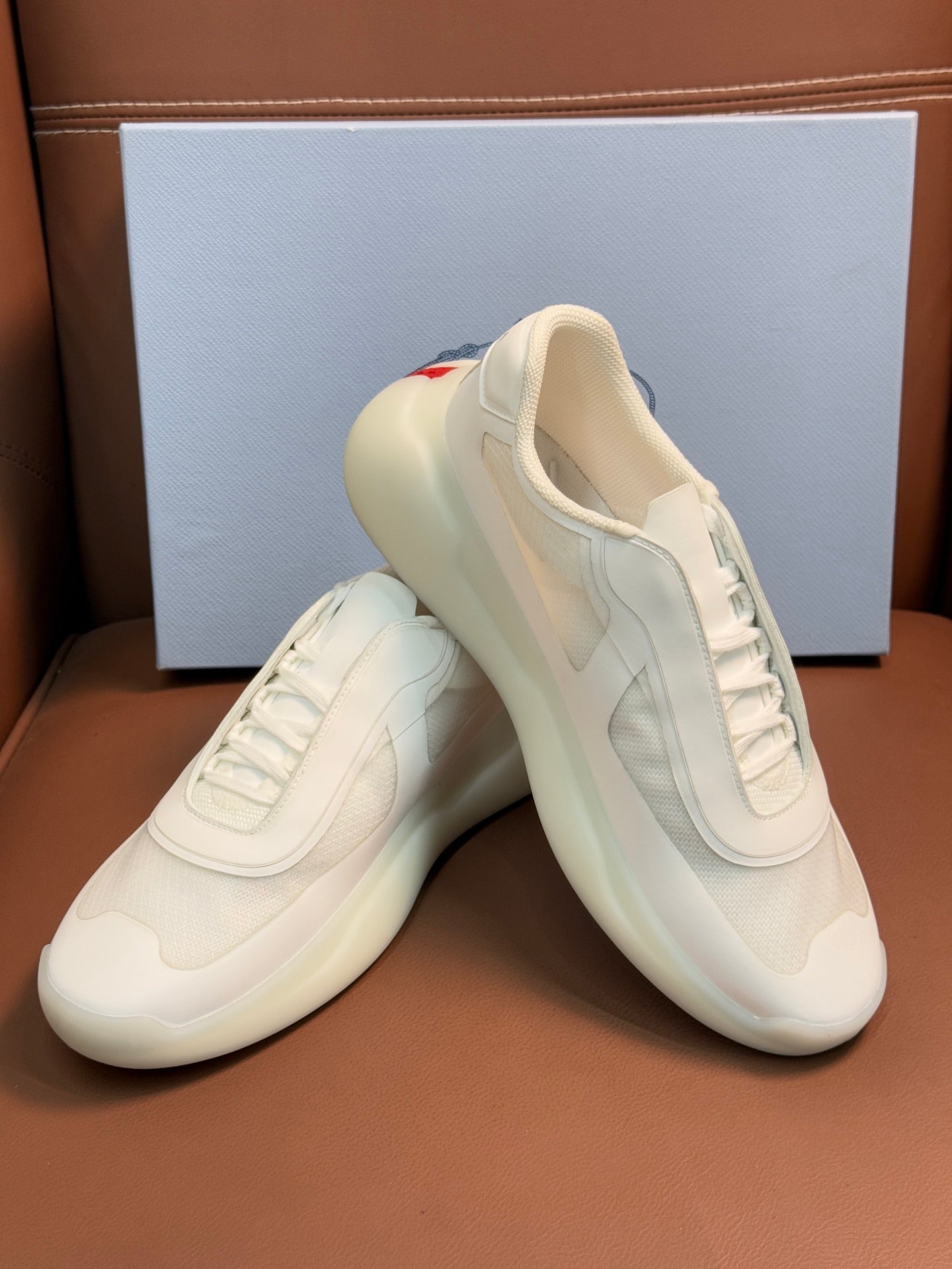 Prada unisex low-top sneakers, light cream leather, heel and lace-up front view