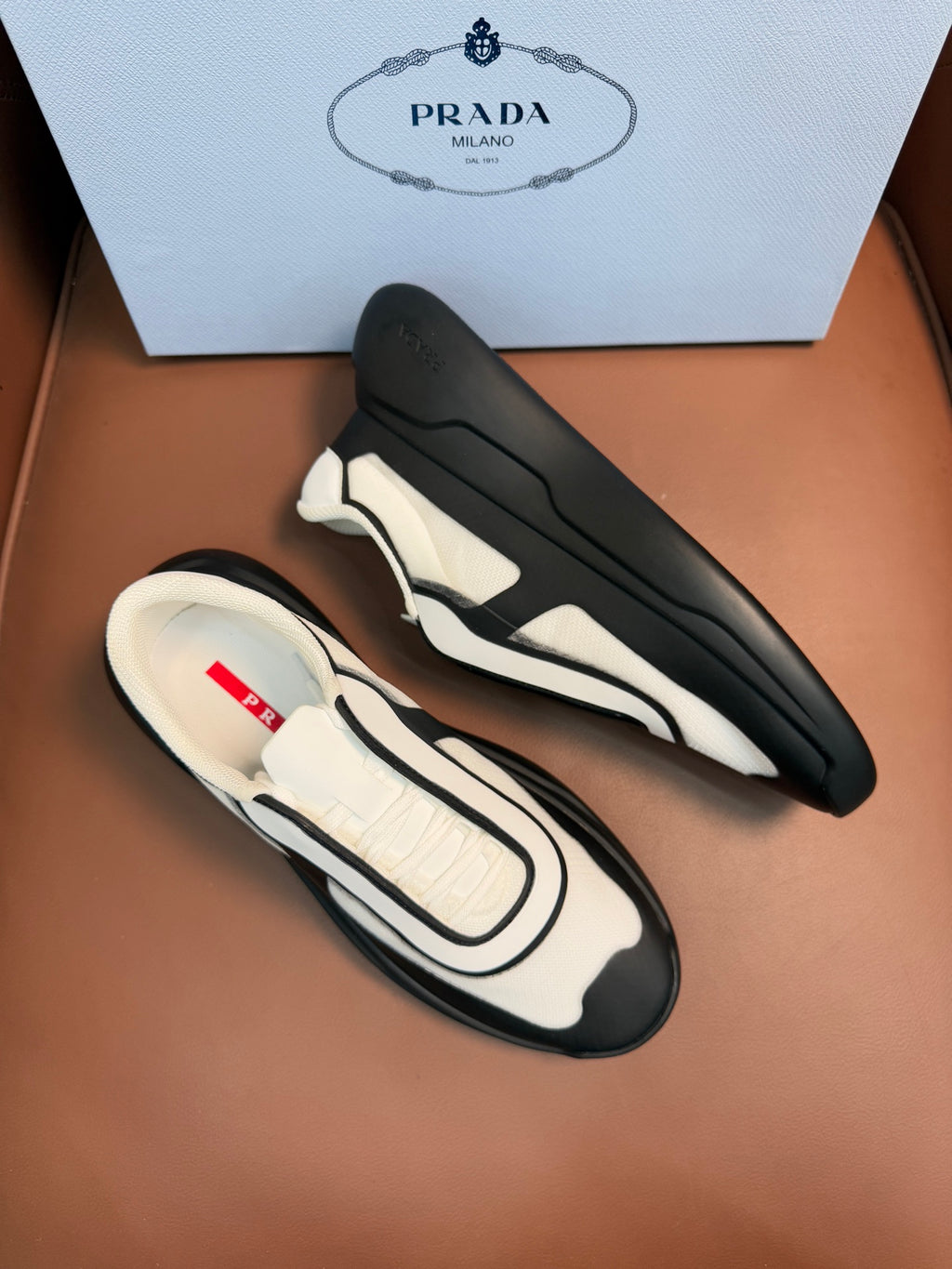 Bi-color sneakers, cream panels and dark gray uppers with thick rubber sole