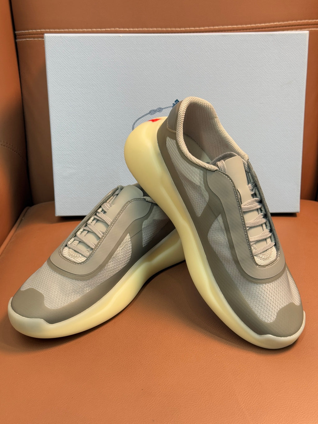 Prada unisex sneakers, cream-beige upper with gray panels, laced, thick yellow sole