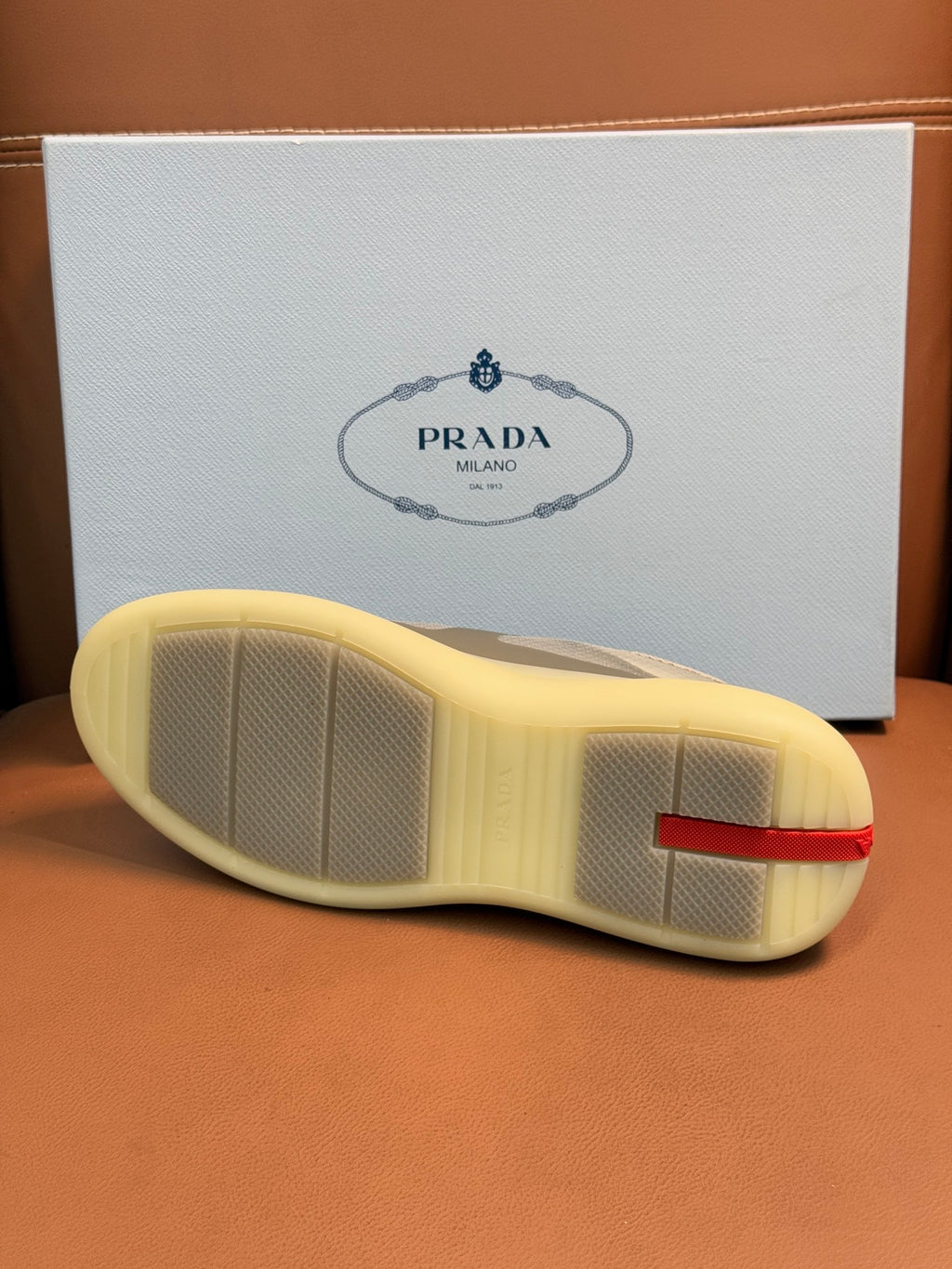 Prada unisex sneakers outsole, textured light sole with red logo heel trim