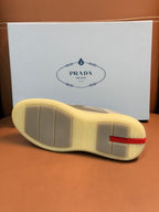 Prada unisex sneakers outsole, textured light sole with red logo heel trim