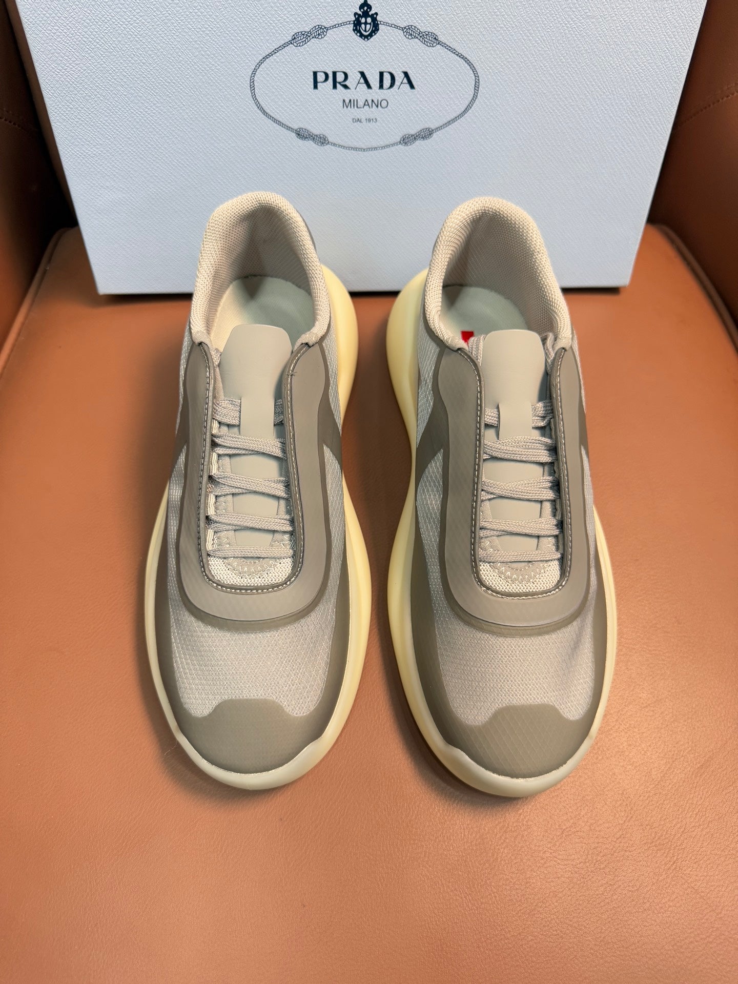 Prada unisex sneakers, cream upper, gray panels, laced front, thick yellow sole