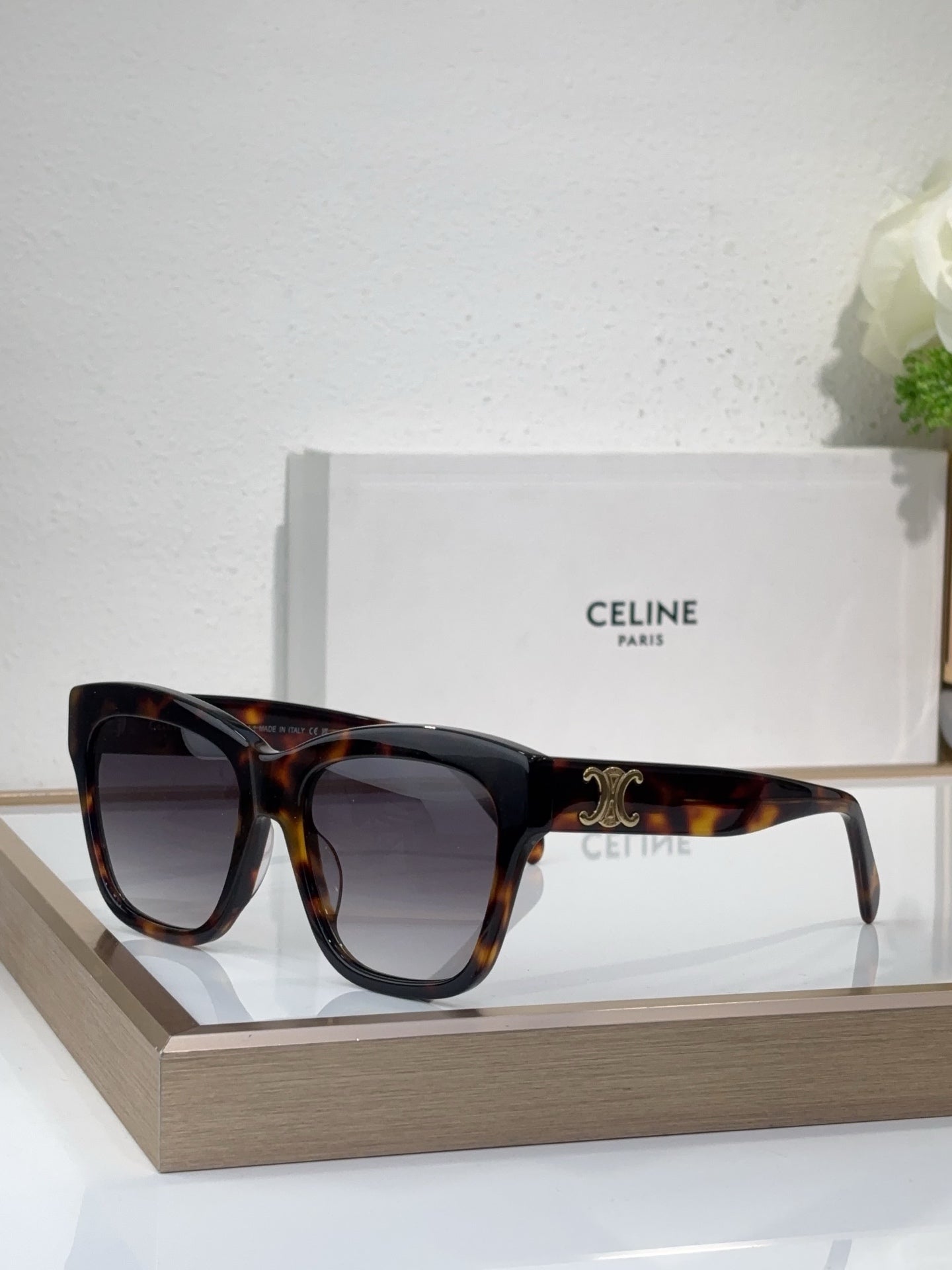 Tortoiseshell sunglasses with square cat-eye frames and dark tinted lenses