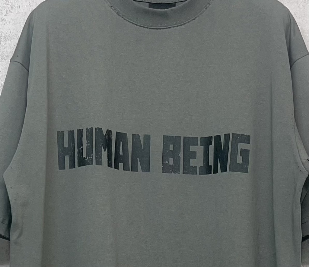 Balenciaga crewneck T-shirt chest graphic “HUMAN BEING” on gray-green fabric