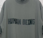 Balenciaga crewneck T-shirt chest graphic “HUMAN BEING” on gray-green fabric