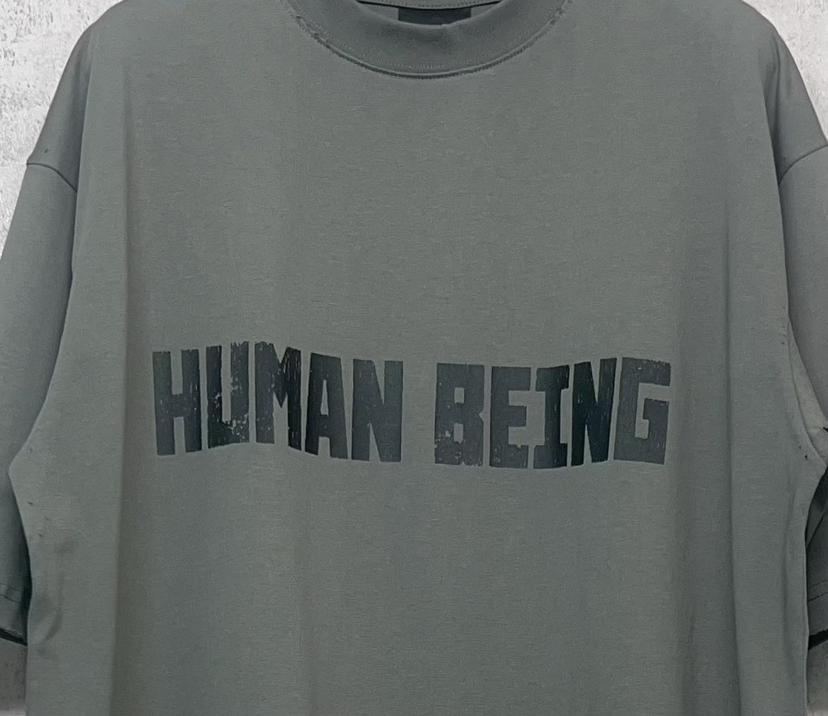 Balenciaga crewneck T-shirt chest graphic “HUMAN BEING” on gray-green fabric