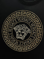 Versace black T-shirt with large gold jeweled Medusa circular emblem on the chest