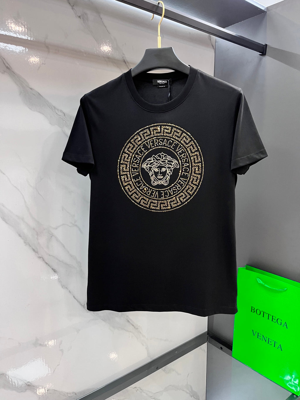 Versace black crewneck T-shirt with gold Medusa circular logo on the chest
