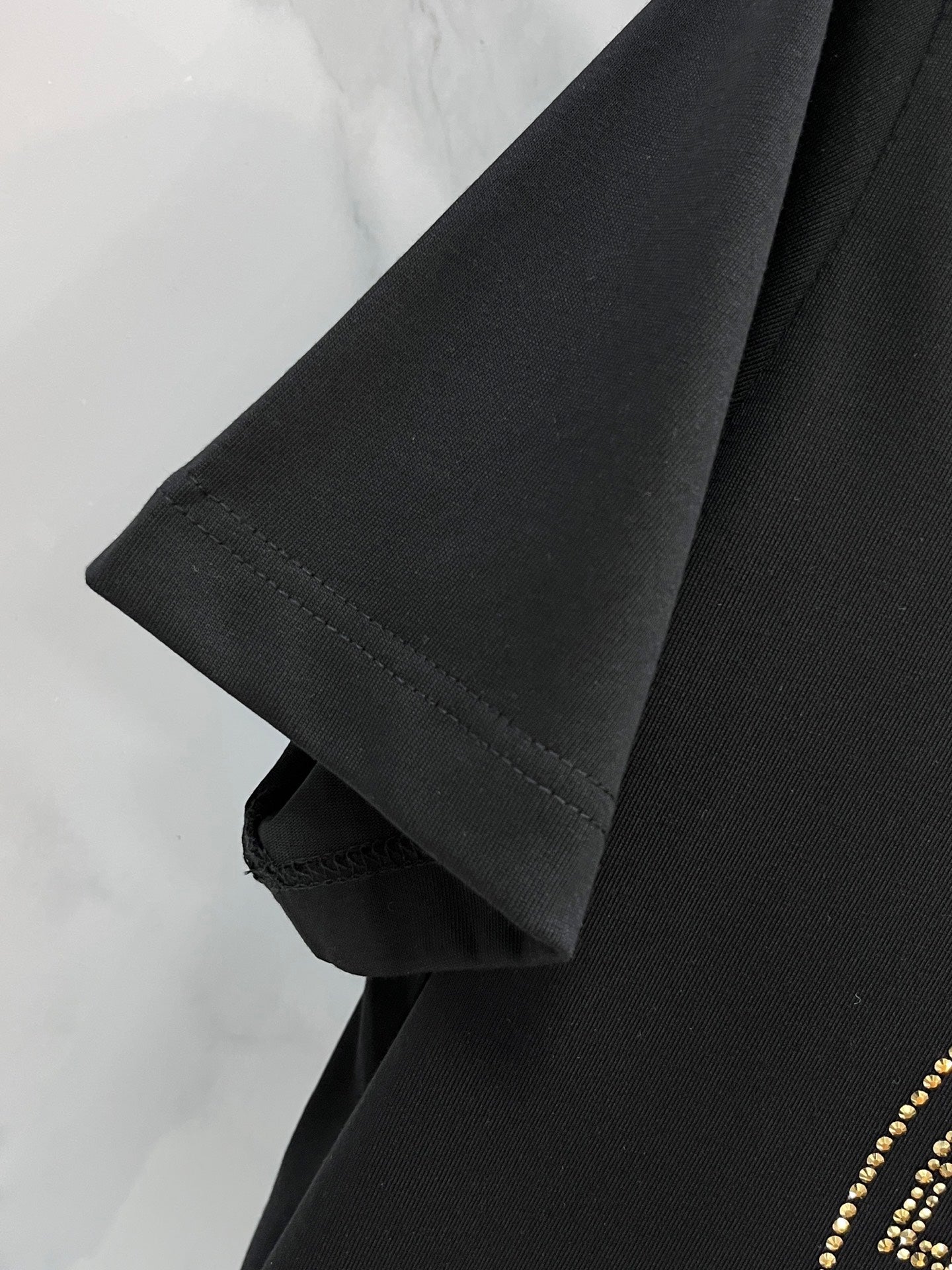 Versace black T-shirt sleeve and hem detail