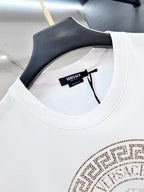 White T-shirt neckline close-up with gold logo details and Versace tag