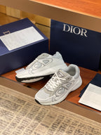Light gray sneakers with lace-up front, padded tongue, and sculpted sole