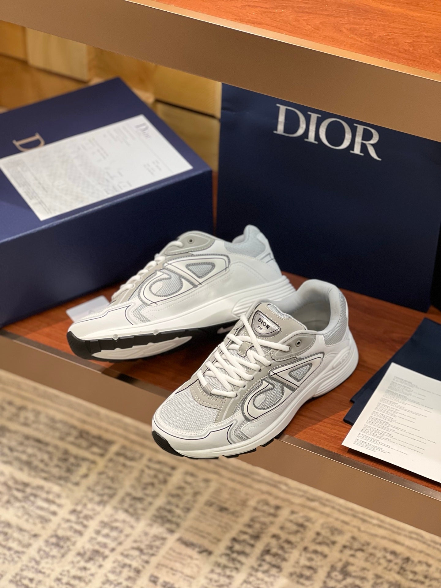 Light gray sneakers with lace-up front, padded tongue, and sculpted sole