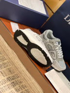 Light gray sneakers with textured tread sole and lace-up upper in view