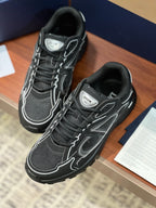 Dior ladies lace-up sneakers, side view: dark gray with white trim and logo patches
