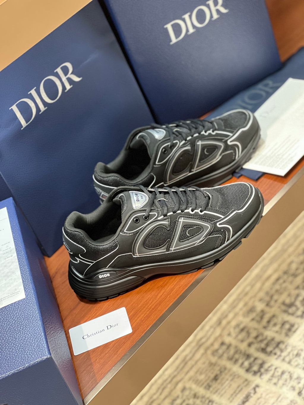 Dior ladies lace-up sneakers, angled view in dark gray with white geometric accents