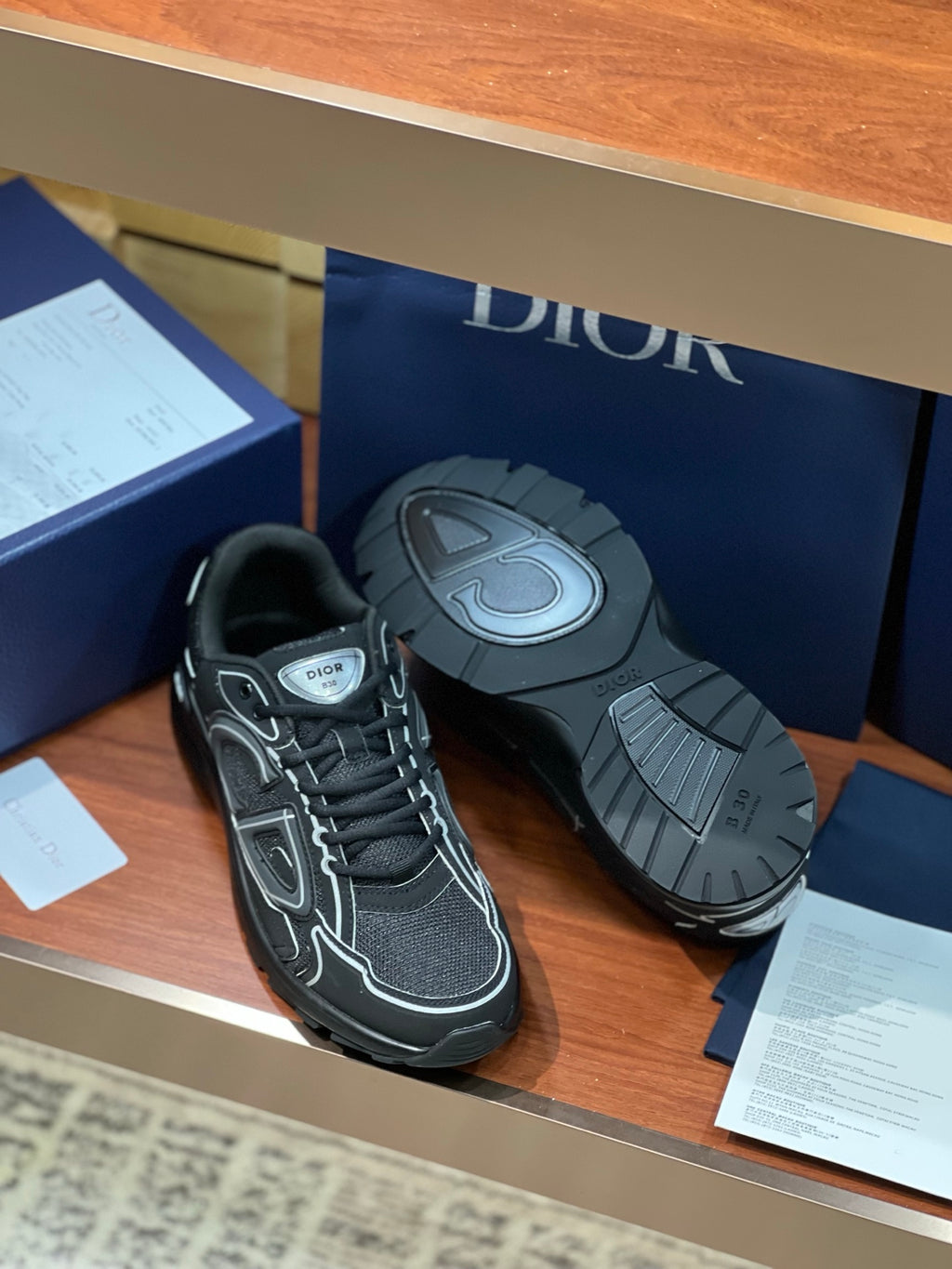 Dior ladies sneakers: dark gray pair with outsole showing tread pattern