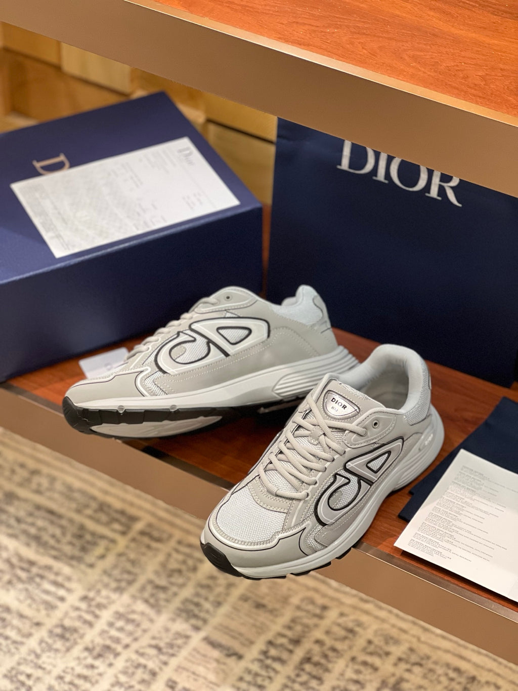 Dior ladies sneaker pair, light gray low-top with thick rubber outsole