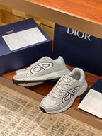 Dior ladies sneaker pair, light gray low-top with thick rubber outsole