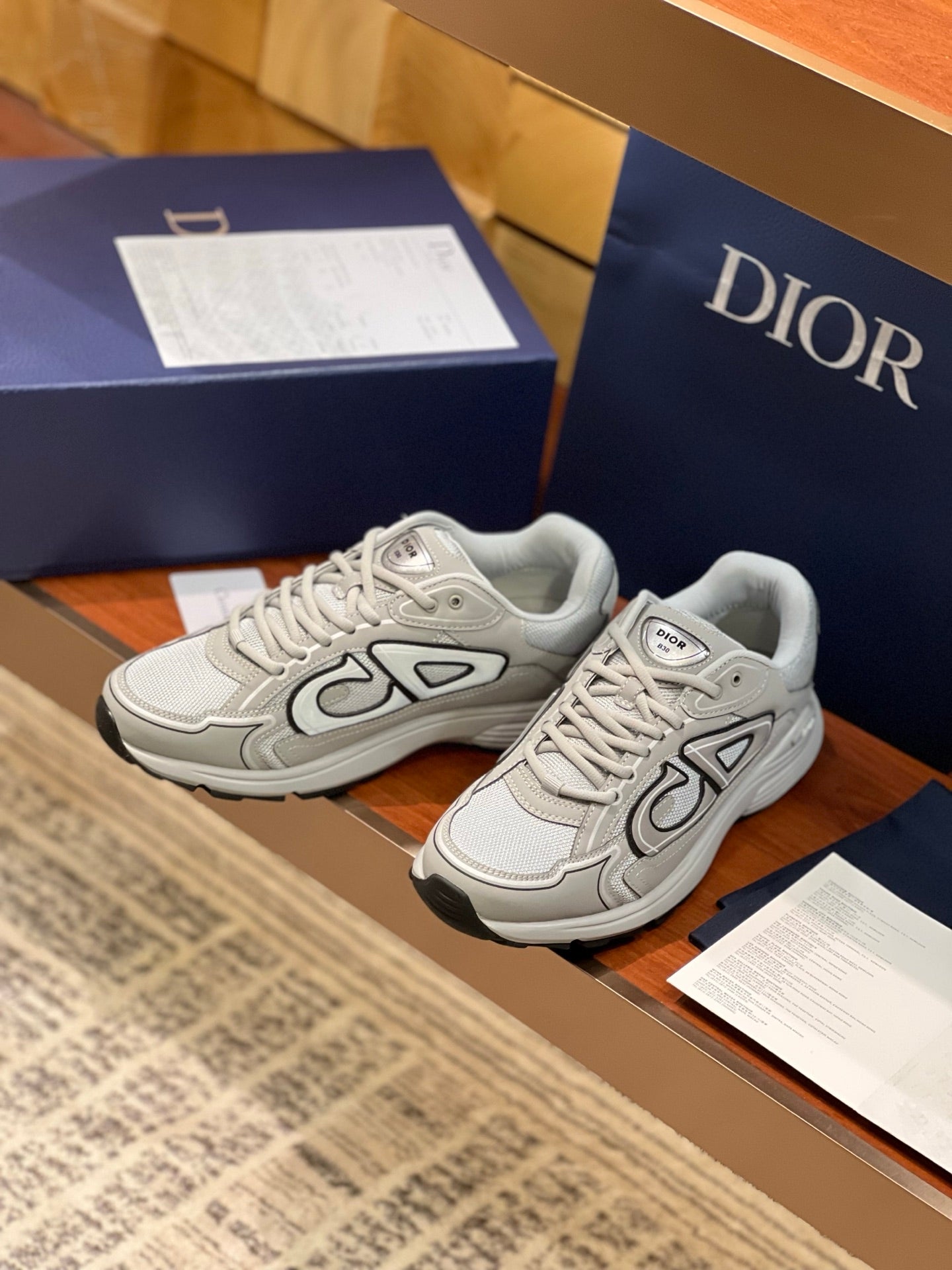 Dior ladies sneakers pair, light gray with lace-up closure and chunky sole