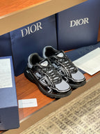 Black and gray lace-up sneakers with bold swirl graphics and chunky rubber sole