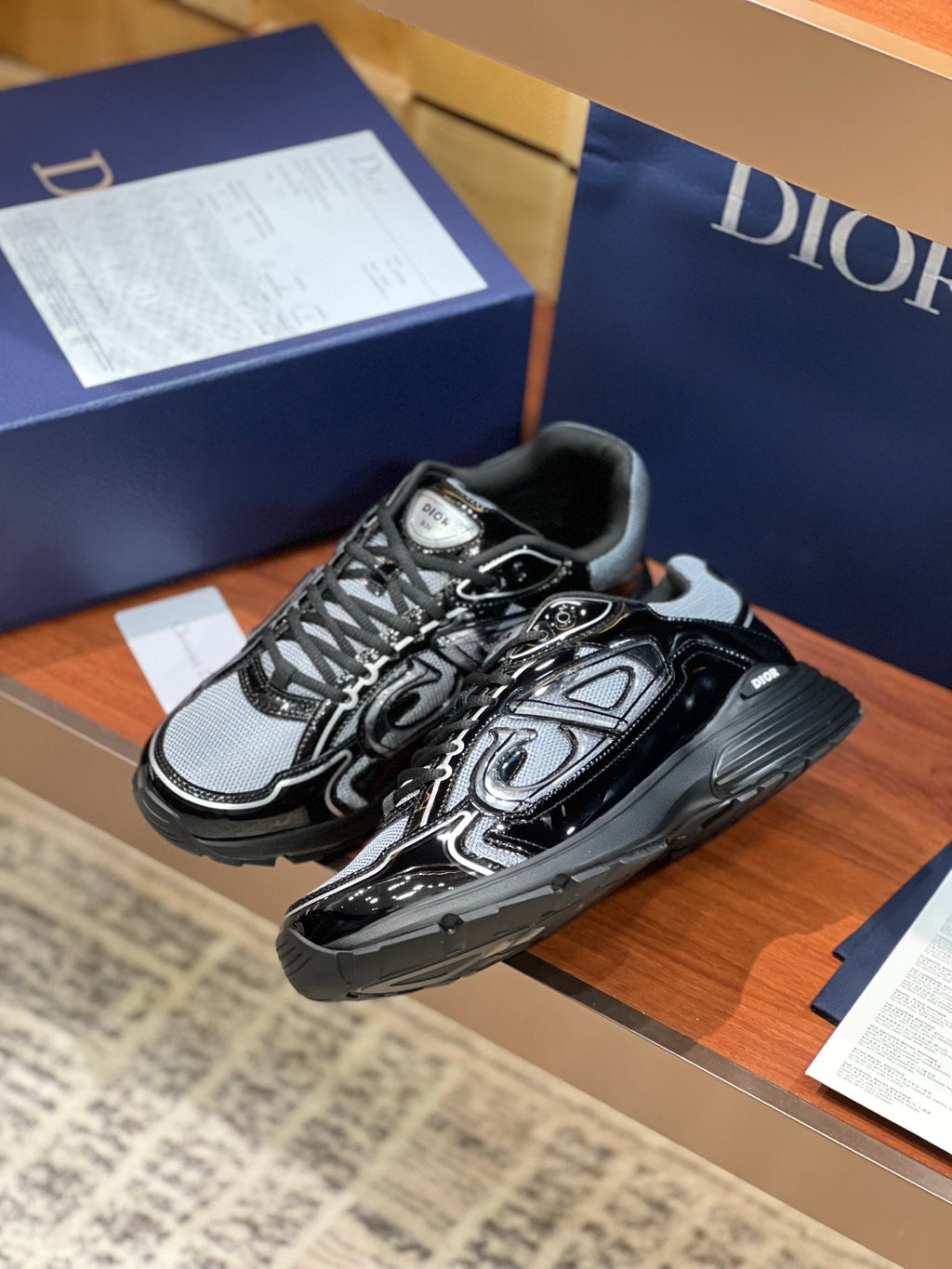 Black and gray lace-up sneakers with swirl pattern overlays and chunky platform sole