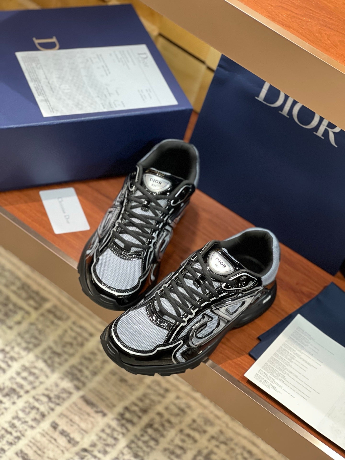 Black and gray lace-up sneakers with Dior-branded tongue and sculpted tread sole