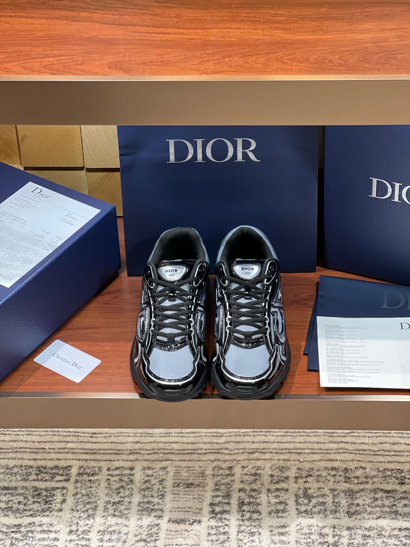 Black and gray lace-up sneakers with chunky sole and Dior logo patch on tongue