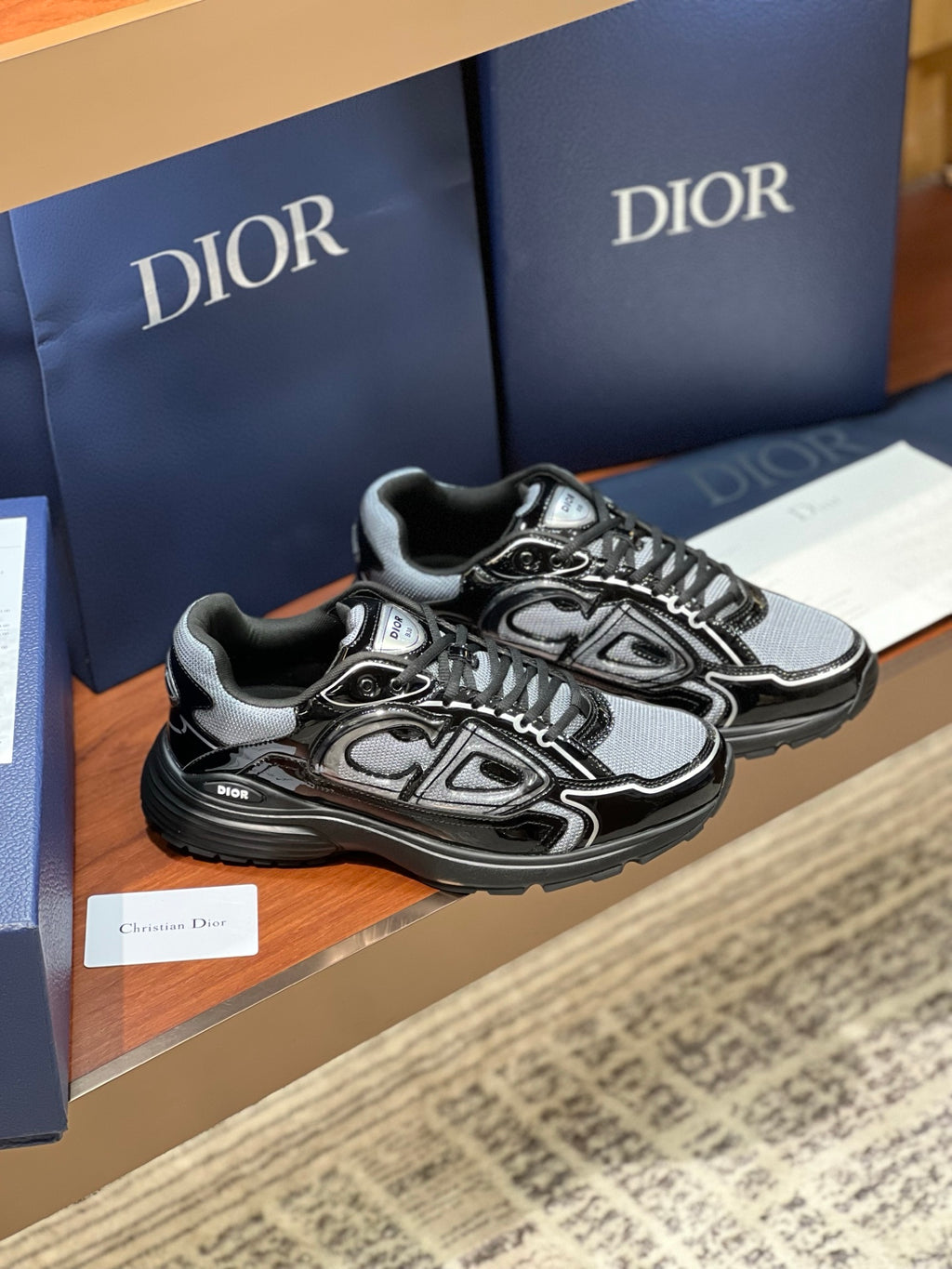 Black and gray lace-up sneakers with front graphic detailing and chunky outsole