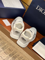White Dior sneakers with gray accents, rear view of lace-up heel and stacked sole