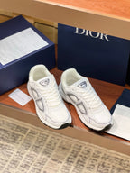 White Dior lace-up sneakers with gray side oval logos and cushioned thick soles