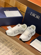 Pair of white Dior lace-up sneakers with gray oval side logos and padded collars