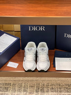 White Dior ladies sneakers with gray logo panels and lace-up front, cushioned sole