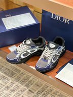 Pair of lace-up chunky sneakers in gray, navy, and white with padded black collar.