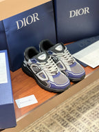 Lace-up chunky sneakers in gray, navy, and white with black outsole and logo patch.