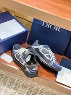 Lace-up sneakers in gray with navy accents and white laces, black rubber sole.