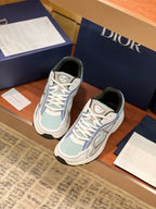 Dior women's lace-up sneakers pair in light blue and white, cushioned collar