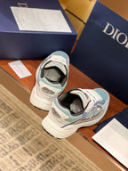 Dior women's sneakers from heel view, light blue and white with rear logo patch
