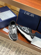 Dior ladies sneakers front view, black with white piping, laces, and logo
