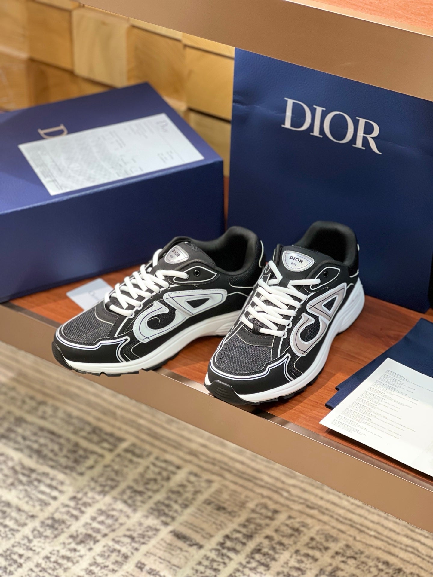 Dior ladies sneakers, two pairs shown, black uppers with white logo and laces